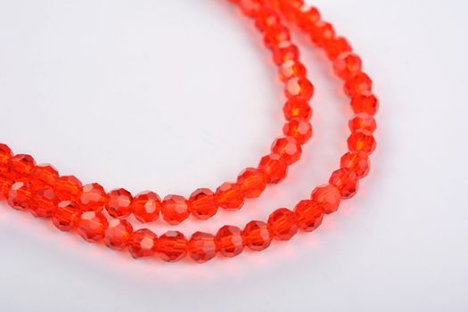 Beautiful Red scarlet, ruby Glass Sparkle Crystal Isoalted Beads on white background. Use for diy beaded jewelry. Space for text