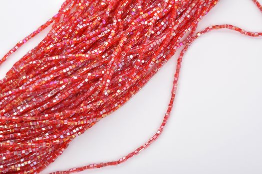 Beautiful Red scarlet, ruby Glass Sparkle Crystal Isoalted Beads on white background. Use for diy beaded jewelry. Space for text