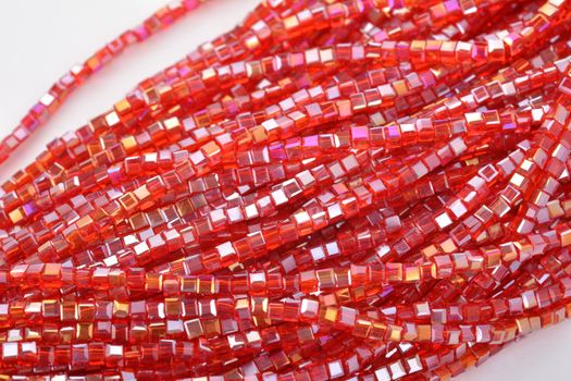 Beautiful Red scarlet, ruby Glass Sparkle Crystal Isoalted Beads on white background. Use for diy beaded jewelry. Space for text