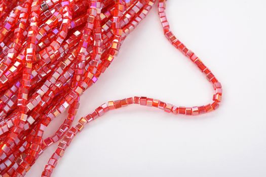 Beautiful Red scarlet, ruby Glass Sparkle Crystal Isoalted Beads on white background. Use for diy beaded jewelry. Space for text