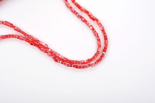 Beautiful Red scarlet, ruby Glass Sparkle Crystal Isoalted Beads on white background. Use for diy beaded jewelry. Space for text