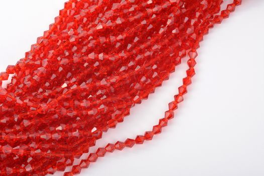 Beautiful Red scarlet, ruby Glass Sparkle Crystal Isoalted Beads on white background. Use for diy beaded jewelry. Space for text