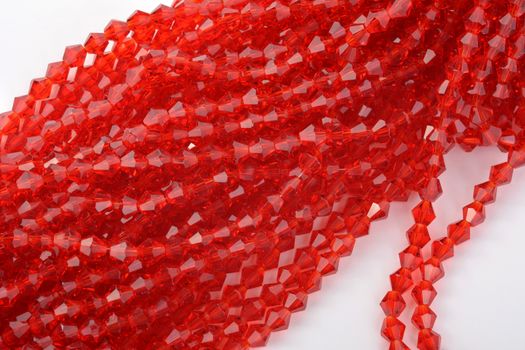 Beautiful Red scarlet, ruby Glass Sparkle Crystal Isoalted Beads on white background. Use for diy beaded jewelry. Space for text