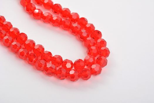 Beautiful Red scarlet, ruby Glass Sparkle Crystal Isoalted Beads on white background. Use for diy beaded jewelry. Space for text