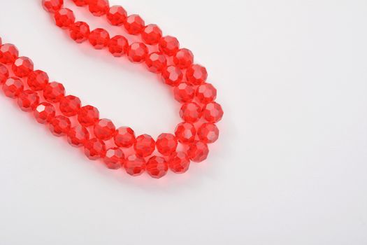 Beautiful Red scarlet, ruby Glass Sparkle Crystal Isoalted Beads on white background. Use for diy beaded jewelry. Space for text