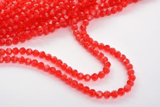 Beautiful Red scarlet, ruby Glass Sparkle Crystal Isoalted Beads on white background. Use for diy beaded jewelry. Space for text