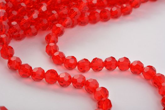 Beautiful Red scarlet, ruby Glass Sparkle Crystal Isoalted Beads on white background. Use for diy beaded jewelry. Space for text