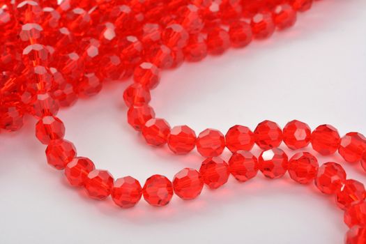 Beautiful Red scarlet, ruby Glass Sparkle Crystal Isoalted Beads on white background. Use for diy beaded jewelry. Space for text