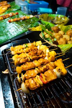 Asian food. Different mini barbecue counter at night street food market