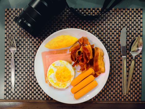 top view of breakfast on table with fork, spoon and camera