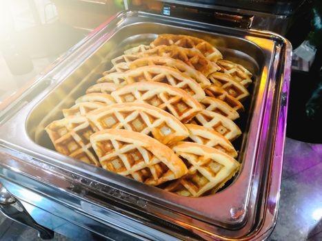 Waffles are prepared for customers in restaurants.