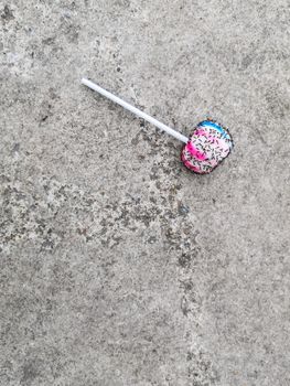 Lollipops on the cement floor and an ant is eating