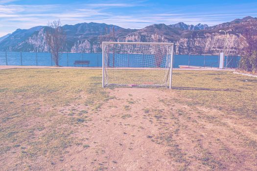 Deserted sports field on the shores of Lake Garda in Italy in faded color effect.