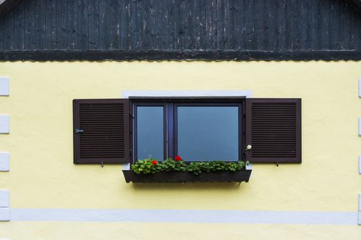 Typical window of a house in a small town in Austria. Home in the Austrian city of Hallstatt on a rainy day. 