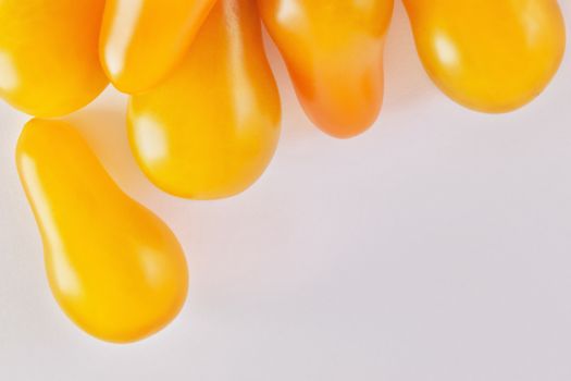 Yellow tomatoes  on a white background ,pear shape tomato , studio shot , horizontal composition  