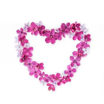 Heart made of lilac petals. Greeting card with heart and five-pointed lilac flower. Copy space, mock up