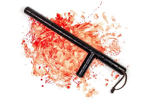 Bloody russian police rubber tonfa baton in blood spatter isolated on white background in top-down flat lay perspective. Natural human blood used.