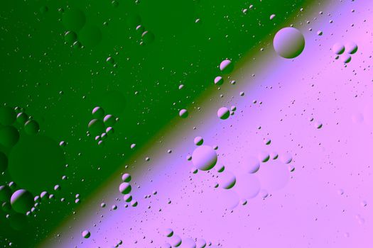 Oil on water flat colorful duotone macro abstract background photographic image. Mint green and plastic pink diagonal soft split line.