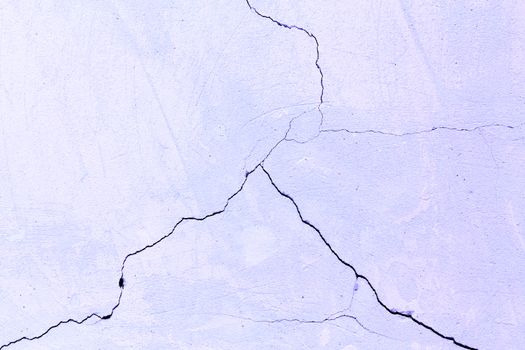 flat texture of cracked light porple plaster wall.