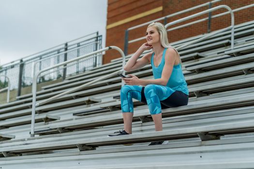 A beautiful young college athlete prepares herself for a track meet at a local university