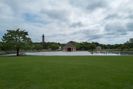 Corolla Park, North Carolina, USA -- June 10, 2020. A wide angle photo overlooking  Corolla Park, NC with the historic boathouse and lighthouse in the