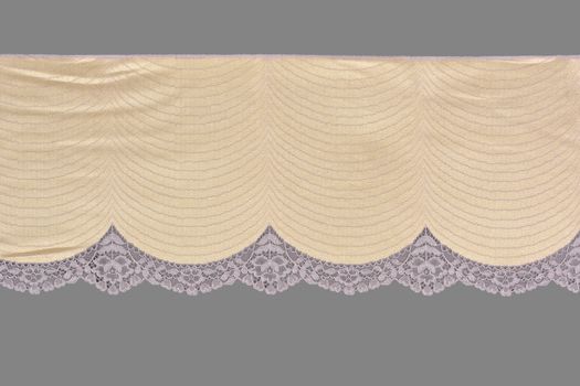 beige pink color straight strip of lace fabric on gray background. Elastic silk nylon braid border. use clothes linen decoration. repeating pattern and interweaving threads. texture for websites
