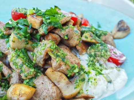 modern cooking with pork tenderloin, potatoes, sour creme and herbs