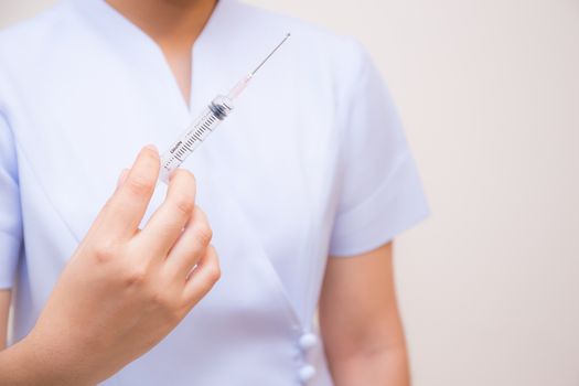 Medical syringe in hand, Nurse or doctor holding medicine vaccination equipment with needle.