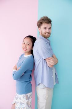 Portrait of a happy couple together standing retro color background