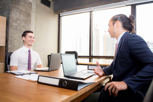 American young businessmen interacting and talking teamwork at meeting in office.