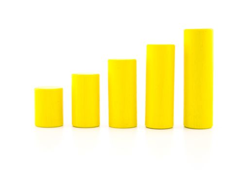 building a growing financial graph using yellow color wood toy isolated on white background, finance successful business concept.