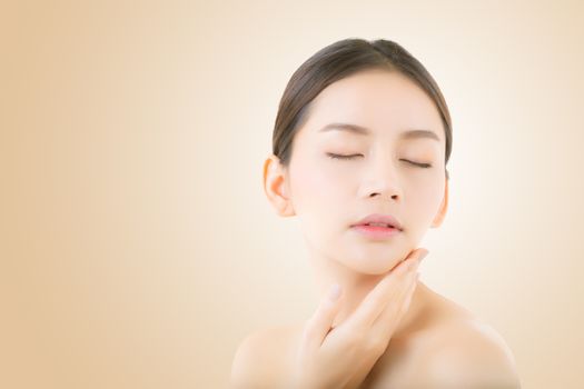 Beautiful girl with makeup, woman and skin care concept / attractive asia girl smilling on face on yellow background.