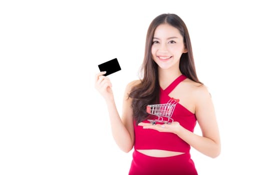 Asian woman in shopping concept isolated on white background girl holding shopping cart and credit card holding hand. 