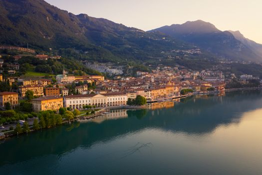 Drone view of Lake Iseo at sunrise, on the left the city of lovere which runs along the lake,Bergamo Italy.