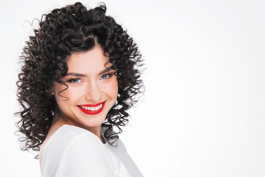 Beauty young woman portrait isolated on white background. Girl with black curly hair. Hairstyle. Haircut