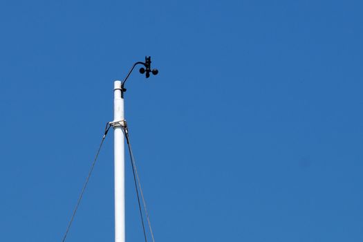 meteorological device for measuring wind speed against a blue sky close-up