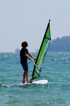 Varna, Bulgaria - July, 31,2020: young guy windsurfing in the sea