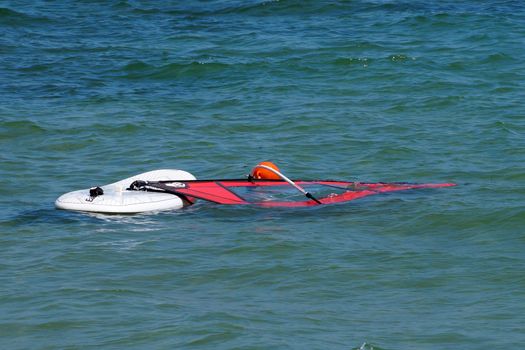 Varna, Bulgaria - July, 31,2020: a board with a windsurf sail float in the sea without people