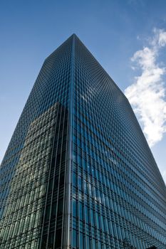 Modern London glass and steel office building rising high to the sky