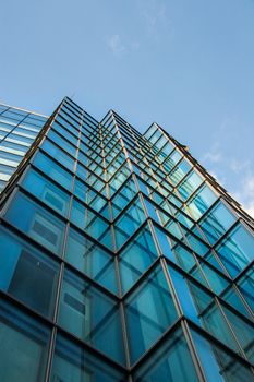 Square windows of modern steel and glass office building rising to skies