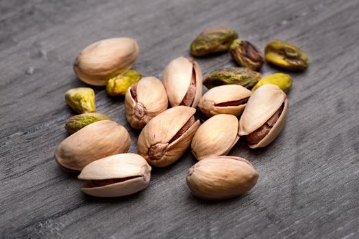 Pile of roasted pistachio nuts (Pistacia vera) in shell and seed