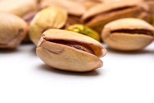 Roasted pistachio nut (Pistacia vera) seed in shell with more nuts