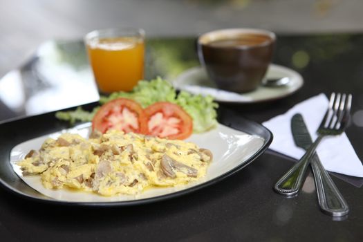 Omelette with mushroom and bacon , orange juice and coffee for background