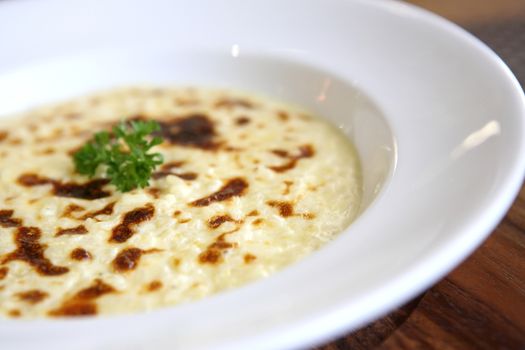 risotto dish with herbs on wood background