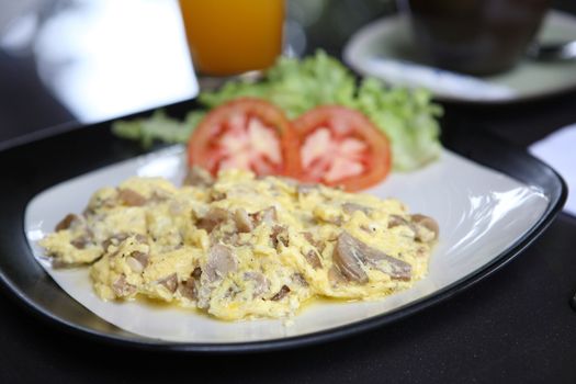 Omelette with mushroom and bacon , orange juice and coffee for background