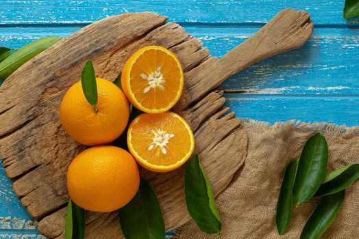 Fresh orange on a wooden table background.