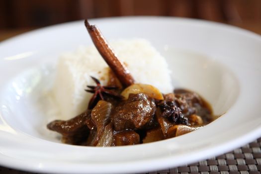 Beef curry with rice , Thai food on wood background