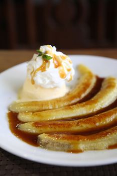 Dessert ice cream with sweet banana on wood background