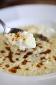 risotto dish with herbs on wood background