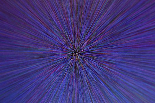 natural lens zoom explosion radial blurred red green blue dots on black background with selective focus.